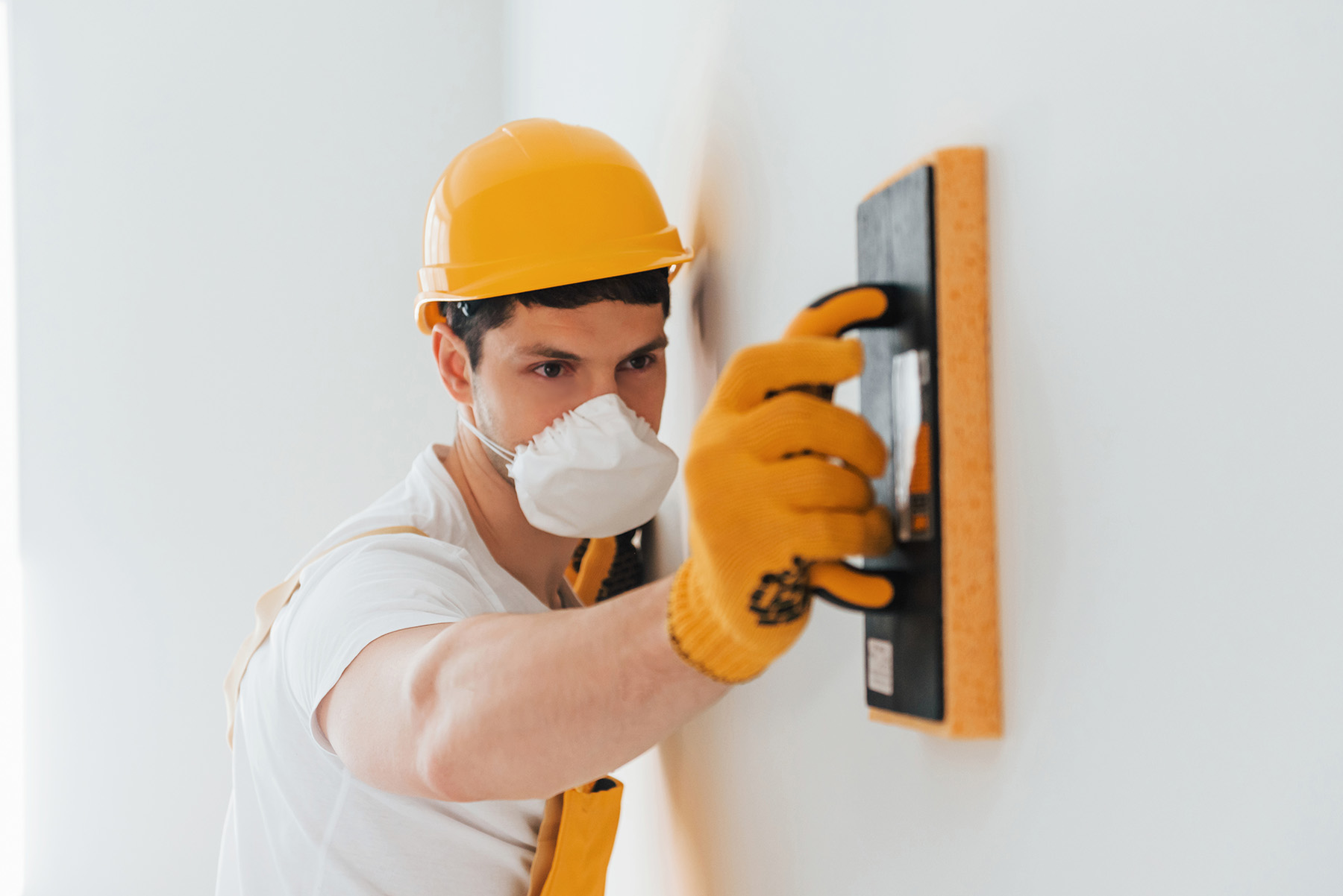 Sanding-a-wall-before-wallpaper-installation-web
